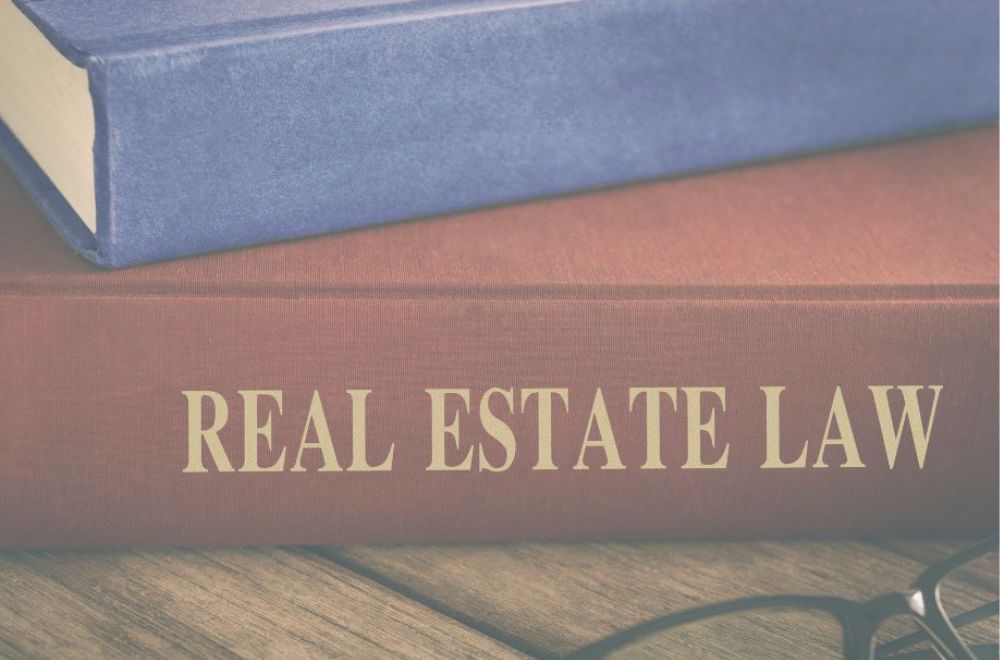 Real Estate Law book and blue book on top